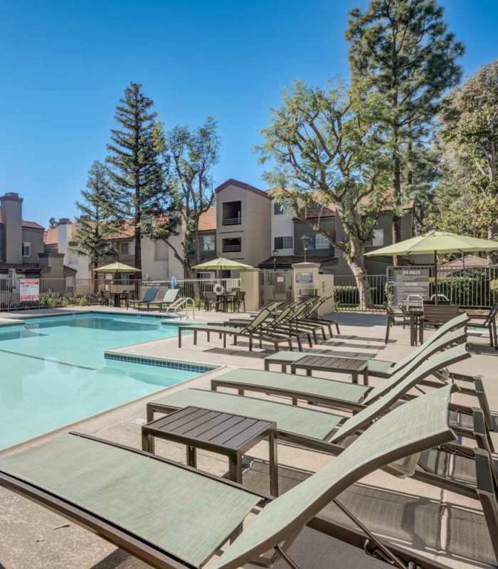 Swimming pool with lounge beds at The Bluffs in Rancho Cucamonga, California