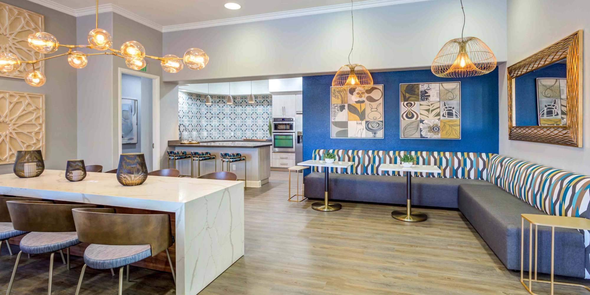 Stylish modern common area with dining table, lounge seating, and decorative accents at Sofi Highlands in San Diego, California