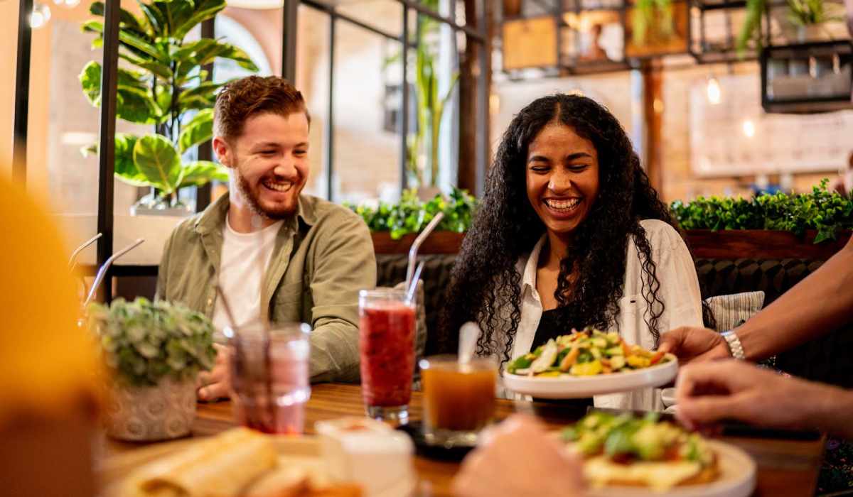 Couple having food near The Moran in Oakland, California