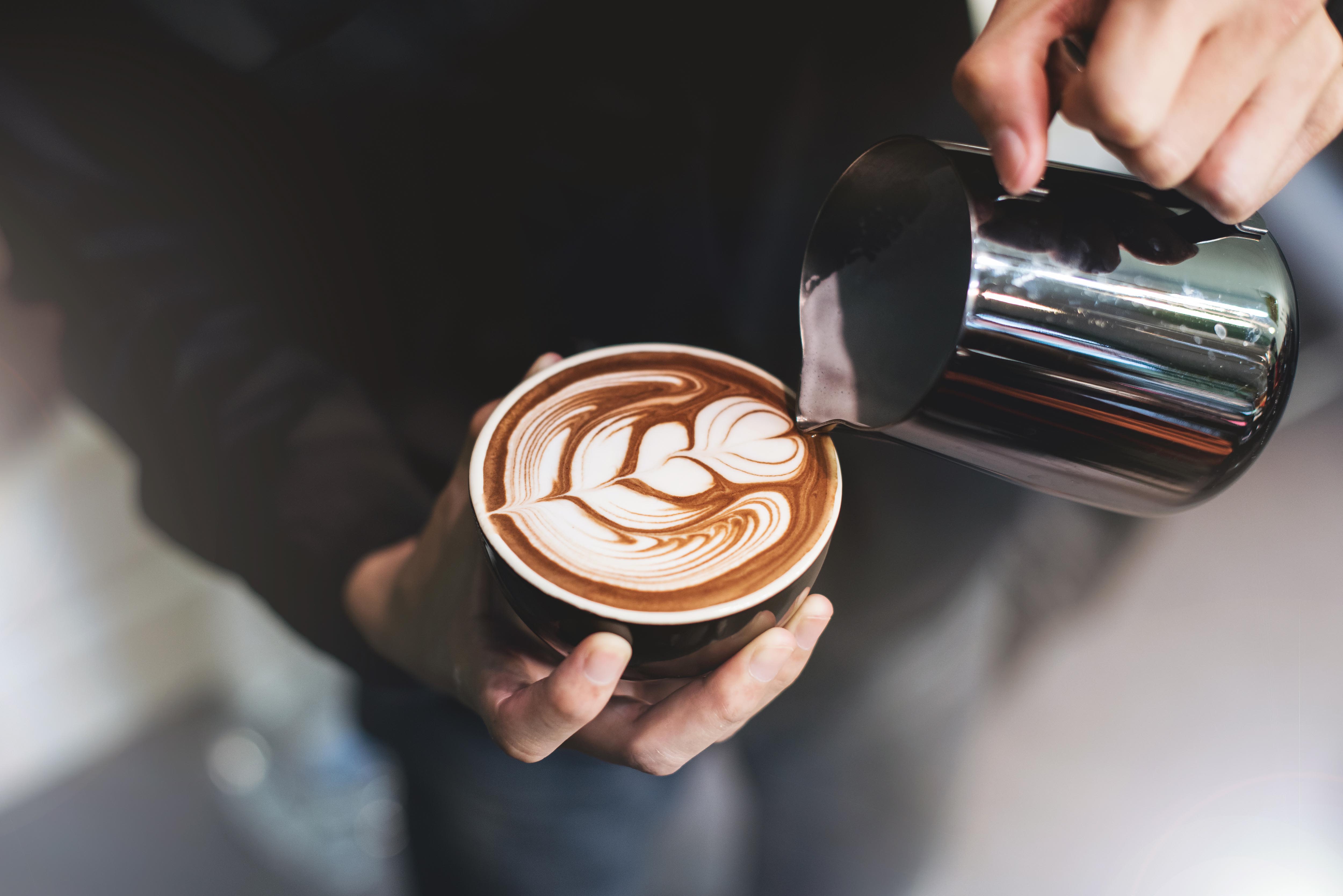 Barista pouring a cup of coffee at a cafe near Arcadia at Rivers Edge in Medford, Massachusetts