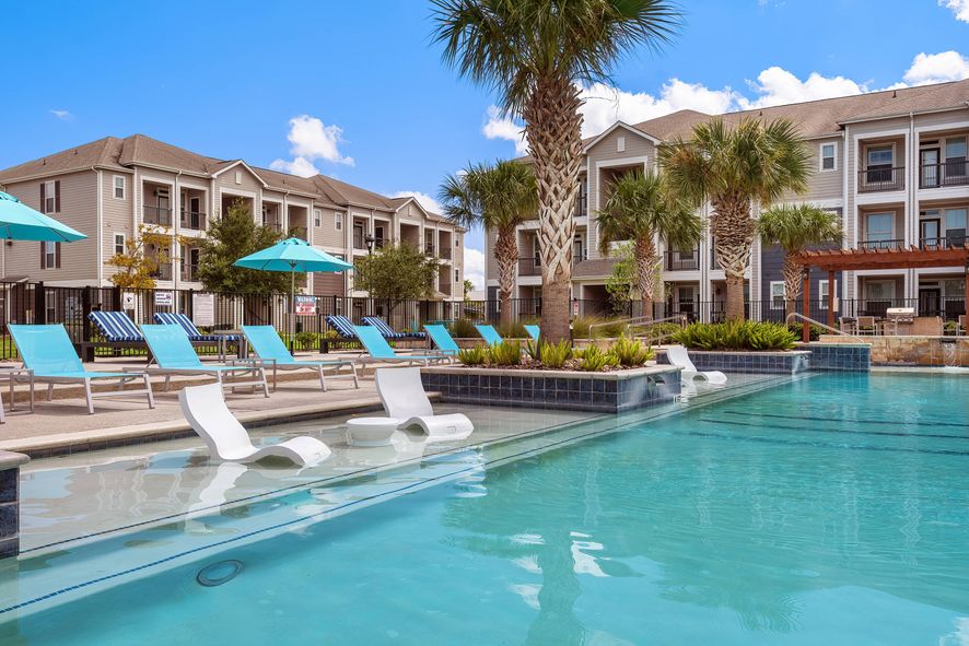 sparkilng resort style pool with wading pool and lounge seating