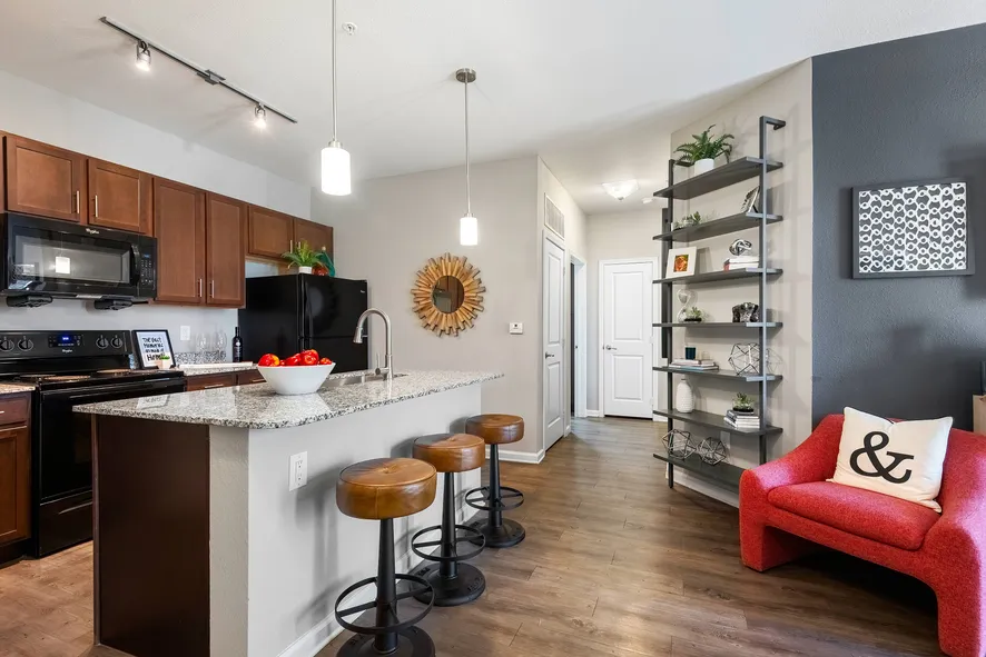 state of the art kicthen with black appliances and island with bar style seating