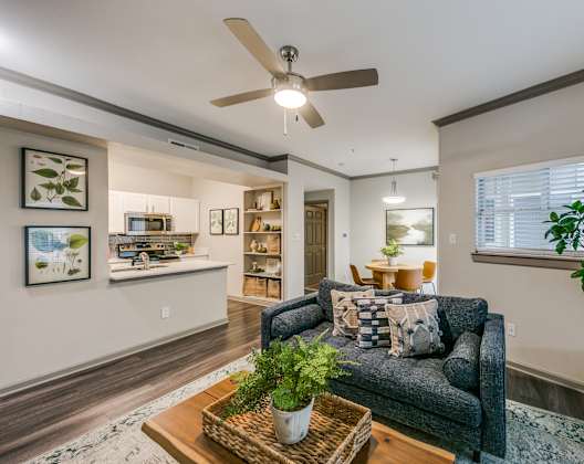 a living room with a couch and a ceiling fan
