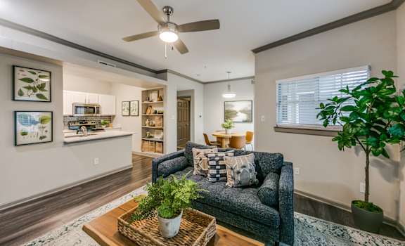 a living room with a couch and a ceiling fan