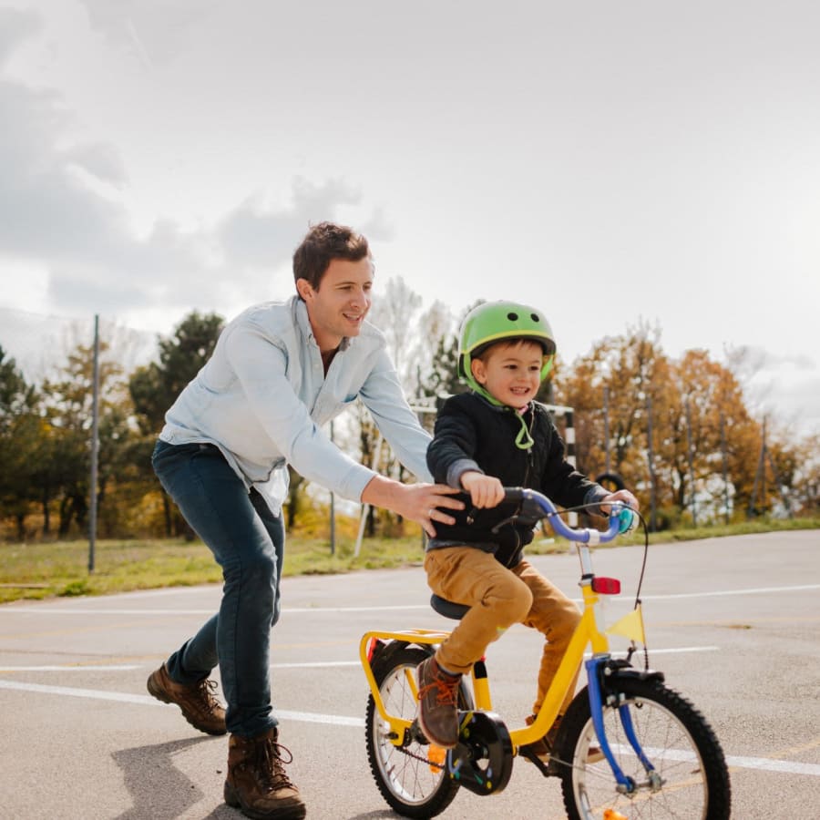 A resident and his child riding a bike near Burrell Square in Rome, Georgia