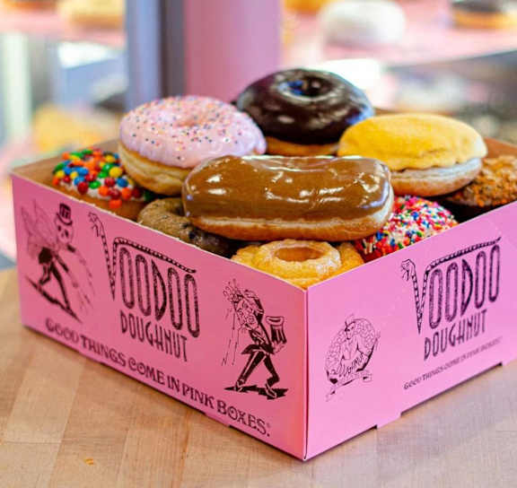 a pink box of doughnuts sitting on a table at AVIA Lofts on Parkway Apartments, Vancouver, 98662