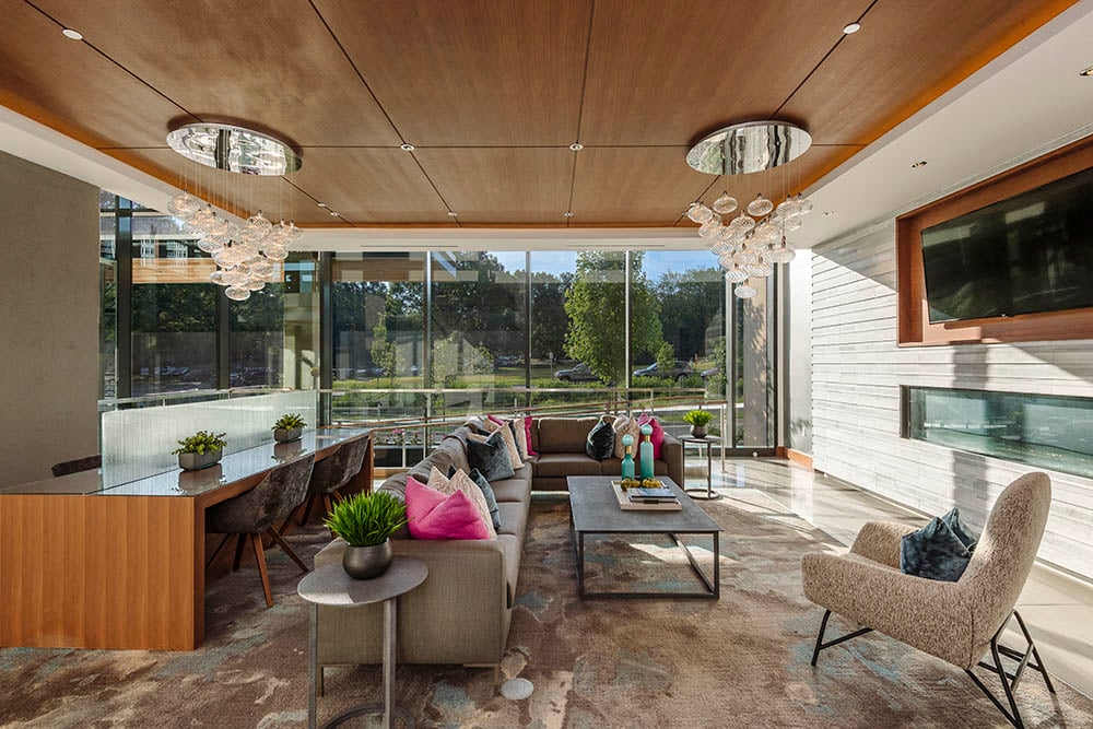 a living room with a long couch and a large window