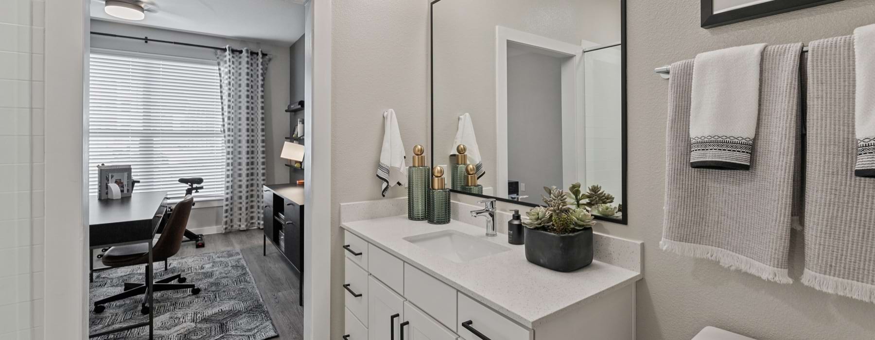 a bathroom with a large vanity and mirror