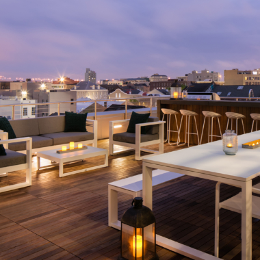 The Beacon at South Market private rooftop courtyard with bar, dining table, 4-piece conversation set, and skyline views of New Orleans.