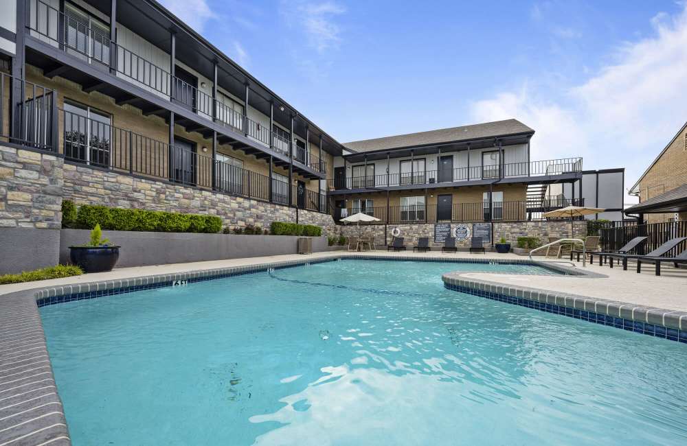Pool, sundeck with lounge beds near resident clubhouse at  Lakeridge Heights in Dallas, Texas