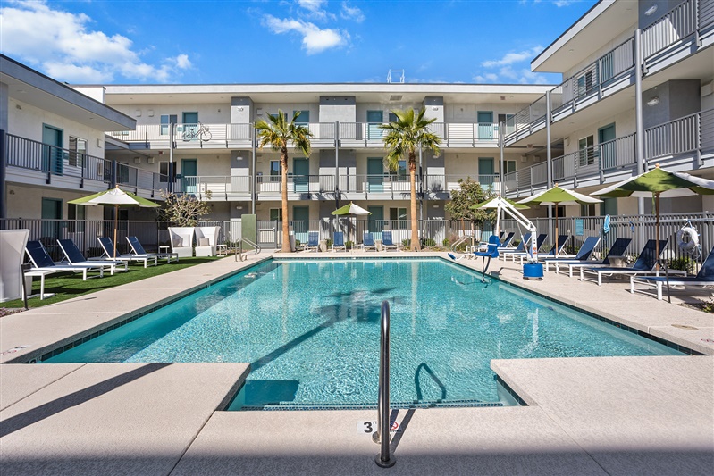 Resort-style swimming pool in a modern apartment complex courtyard