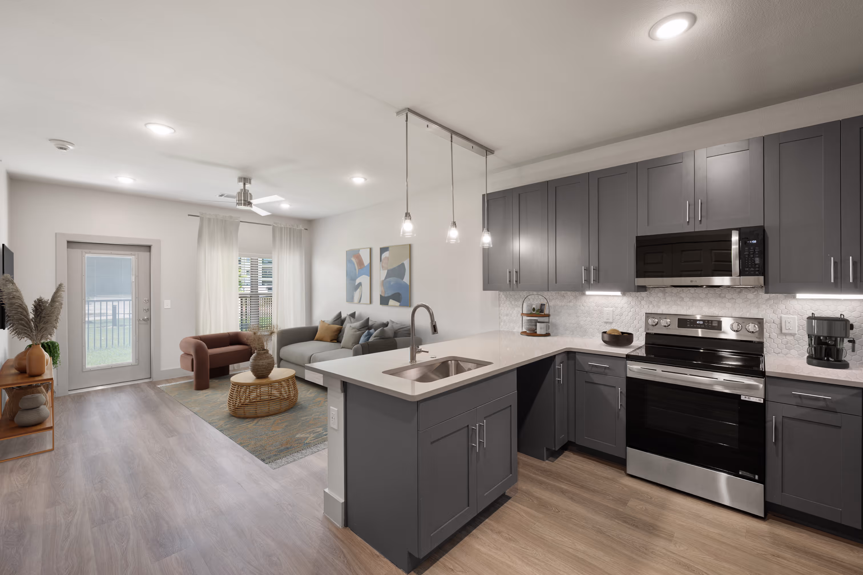 Kitchen with grey cabinets plank flooring and stainless steel appliances