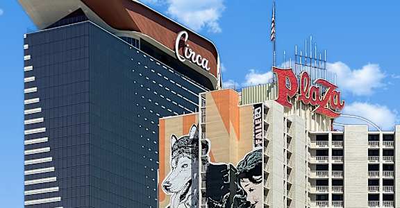 A large mural of a woman and a dog is on the side of a building.