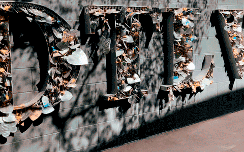 A wall with a tree branch design and leaves on it.