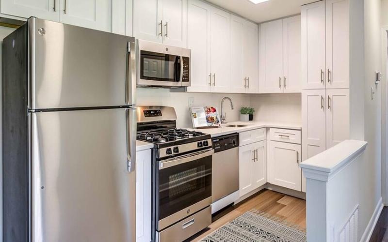 a kitchen with white cabinets