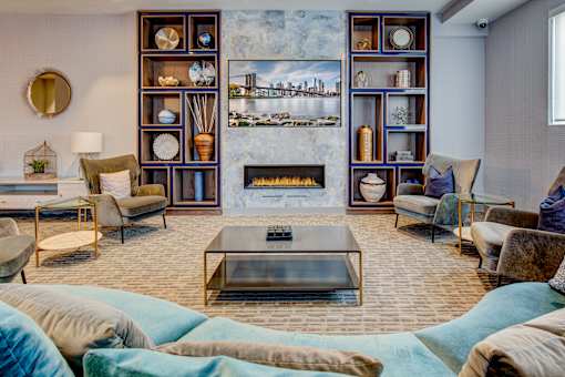 A living room with a fireplace and a large mirror on the wall.