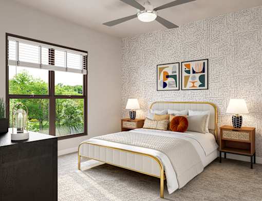 A bedroom with a large bed, a ceiling fan, and a window with blinds.