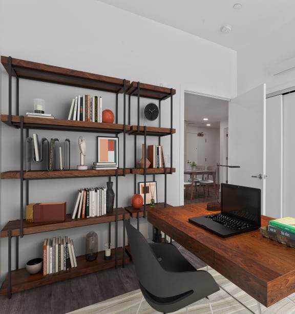 a home office with a wooden desk and a bookshelf