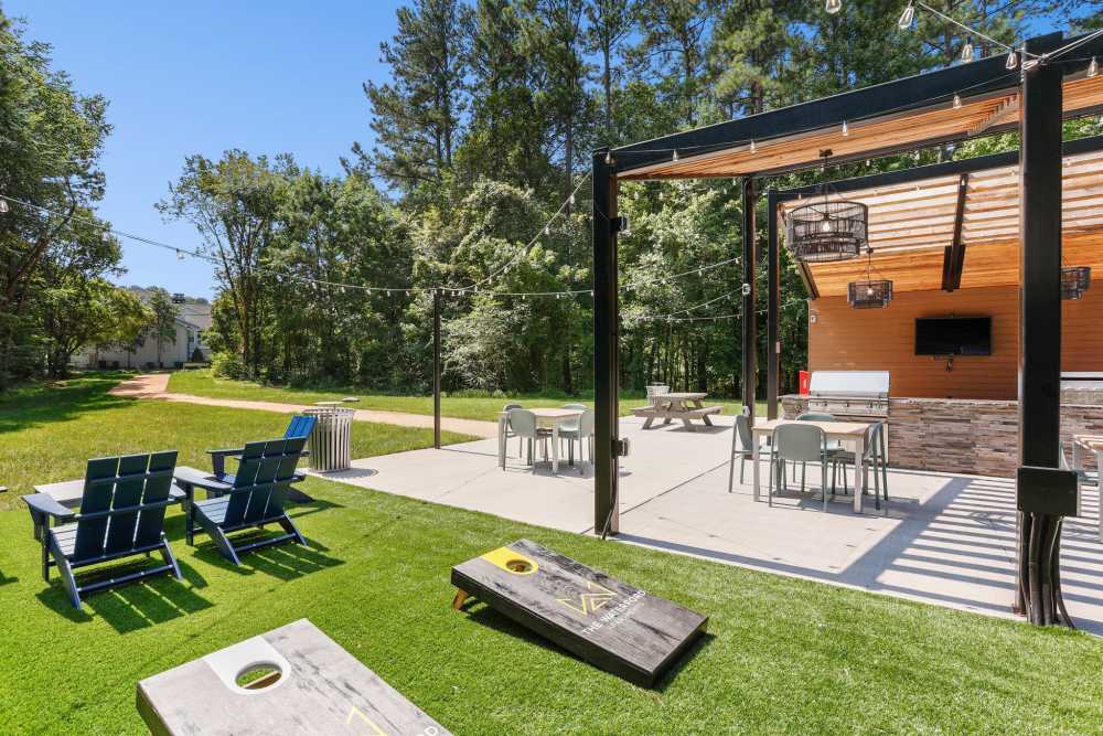Outdoor picnic area with grilling stations at The Waterford in Morrisville, North Carolina
