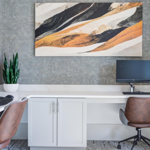 a room with a desk and computers
