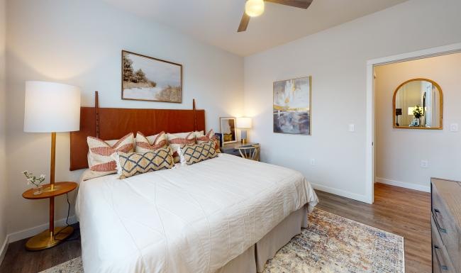 a bedroom with a bed and lamps