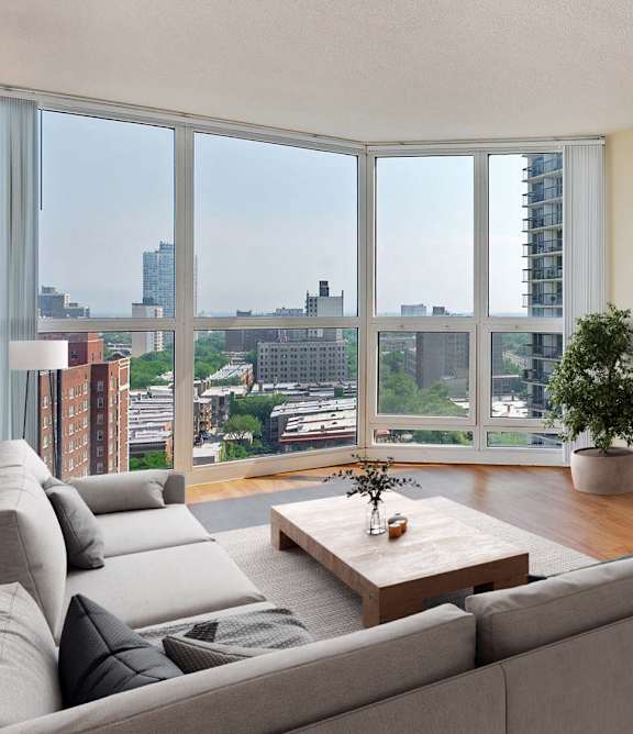 A living room with a grey couch and a wooden coffee table.