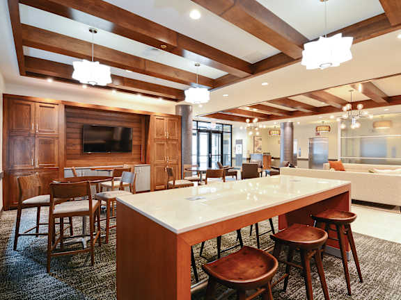 A large kitchen with a long island and wooden cabinets.