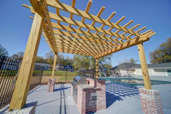a backyard with a barbecue and a pool