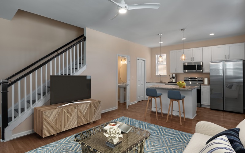 Leland, NC, Pet-Friendly Homes for Rent - Cape Cottages - Living Room with Wood-Style Flooring Set off with Geometric Area Rug, White Sofa, Wooden TV Console, Integrating Open-Concept Space.
