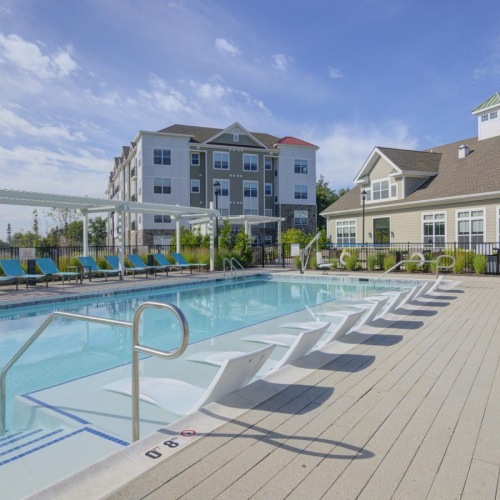 a swimming pool with a building in the background