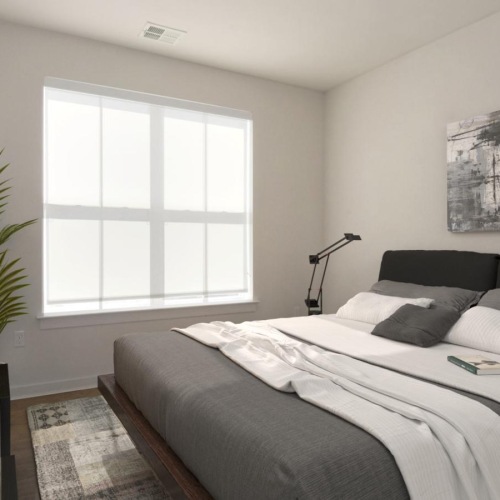 a bedroom with a bed and a plant