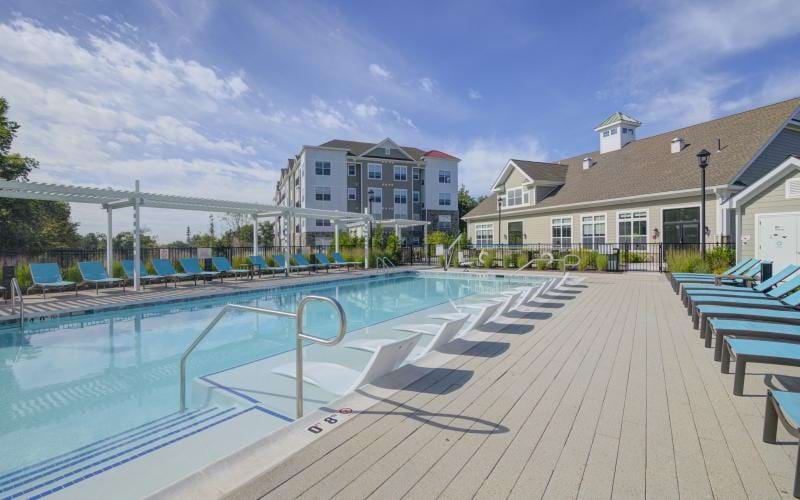 a swimming pool with a building in the background