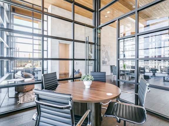 A modern dining area with a round table and chairs.