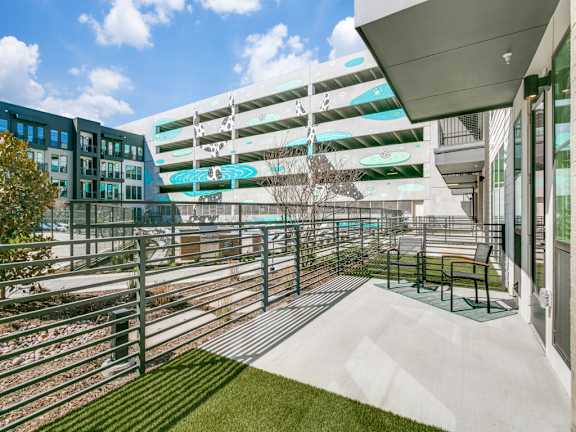 A modern building with a parking garage attached to it.
