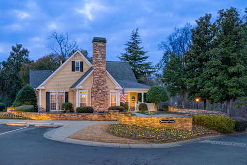 A house with a stone chimney and a flag on the front.