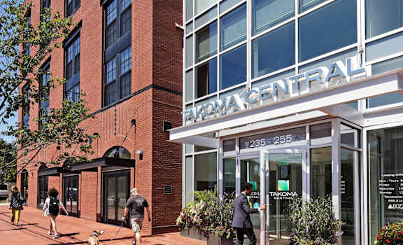 a large brick building with people walking in front of it