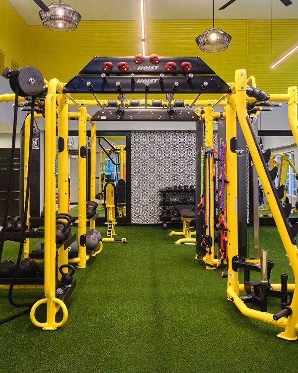 Indoor gym with yellow equipment and astroturf