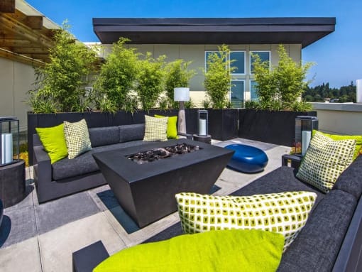 Seattle, WA Modern Apartments - Origin - Rooftop Patio With Incredible Views, Fire-Pit, Outdoor Lights, and Lounge Seating.