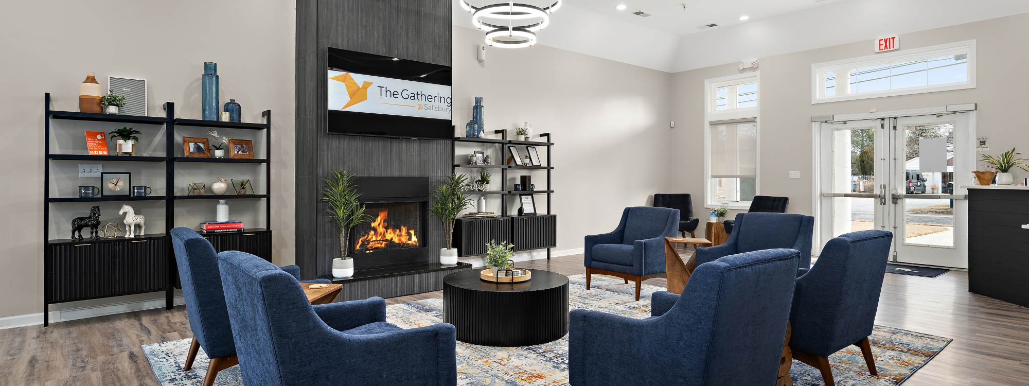 Resident lounge with fireplace and plenty of seating at The Gathering in Salisbury, Maryland