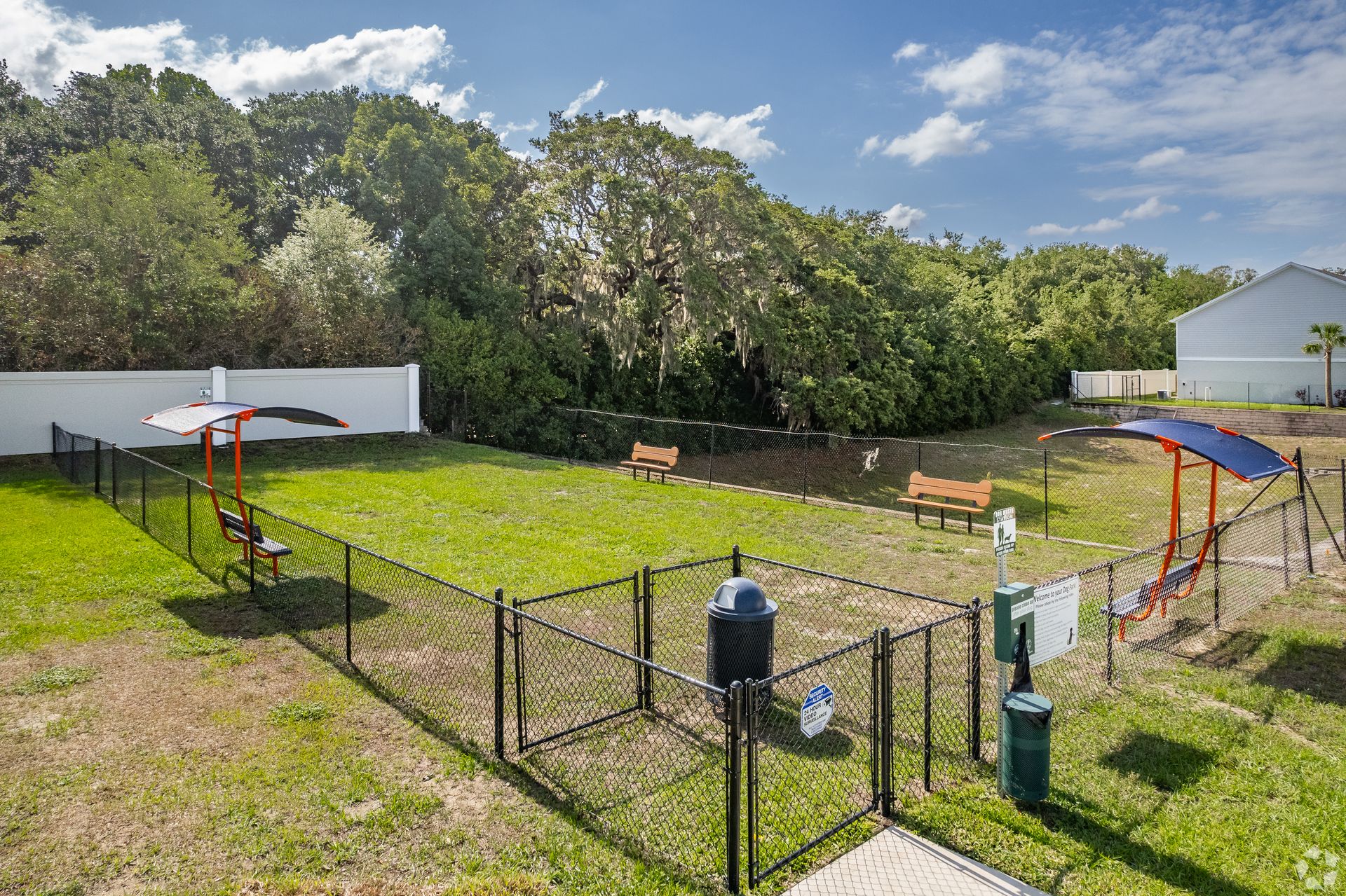 An aerial view of a dog park with a fence and benches.