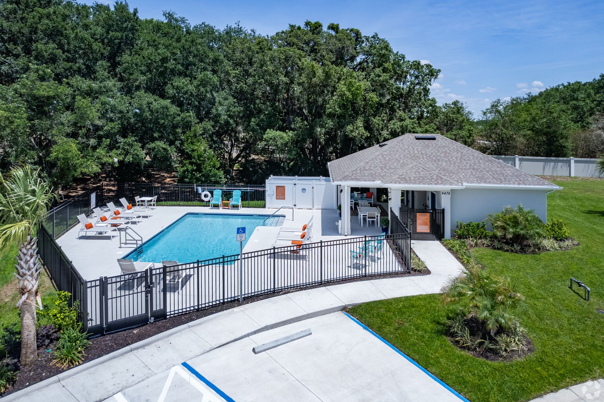An aerial view of a swimming pool surrounded by a fence.