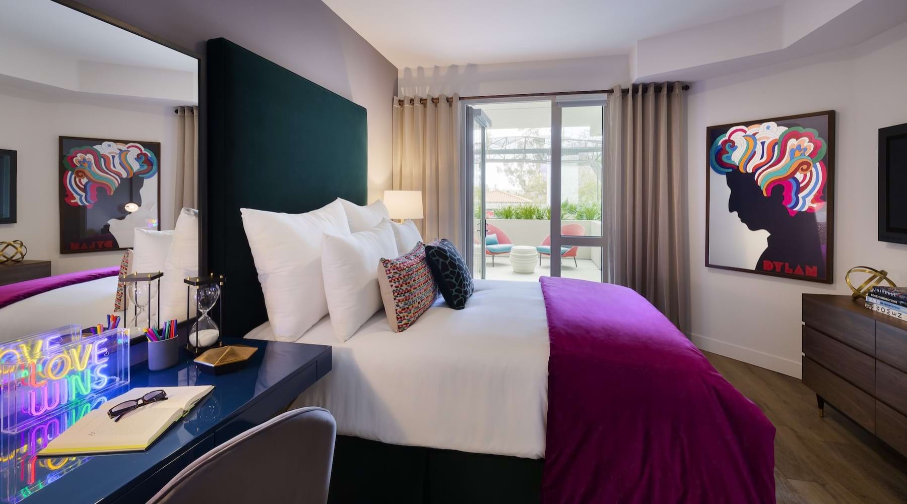 a bedroom with a bed, a desk and a chair