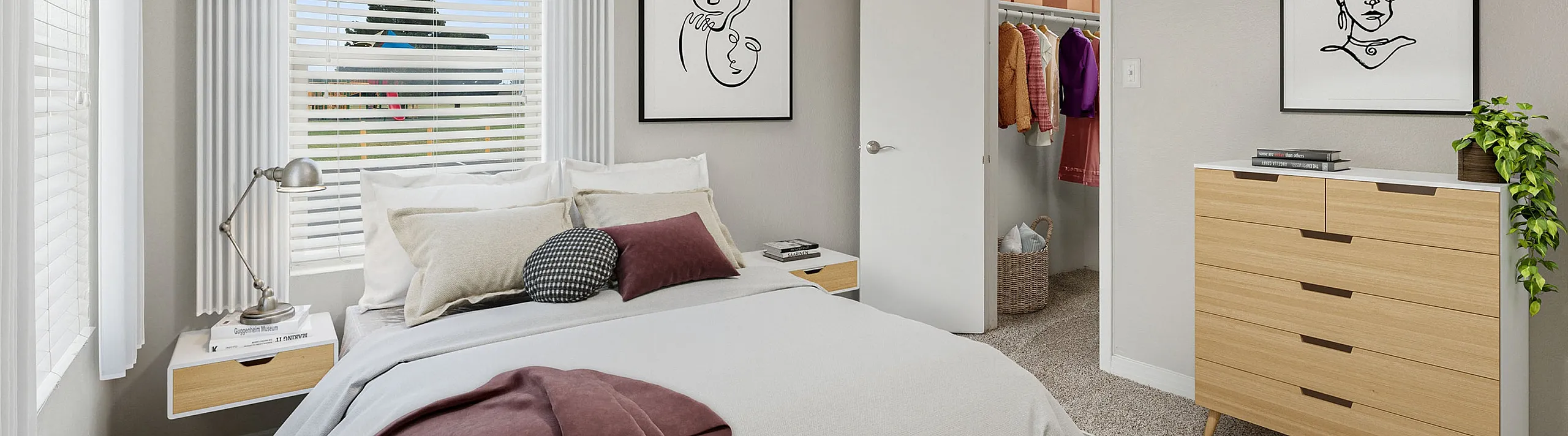 Elegant bedroom at ReNew Midland with modern decor, plush bedding, and ample natural light from large windows, featuring a stylish open closet and chic wall art.