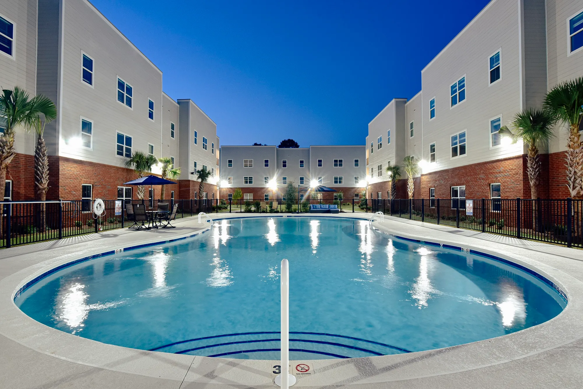 Resort Style pool with deck at night