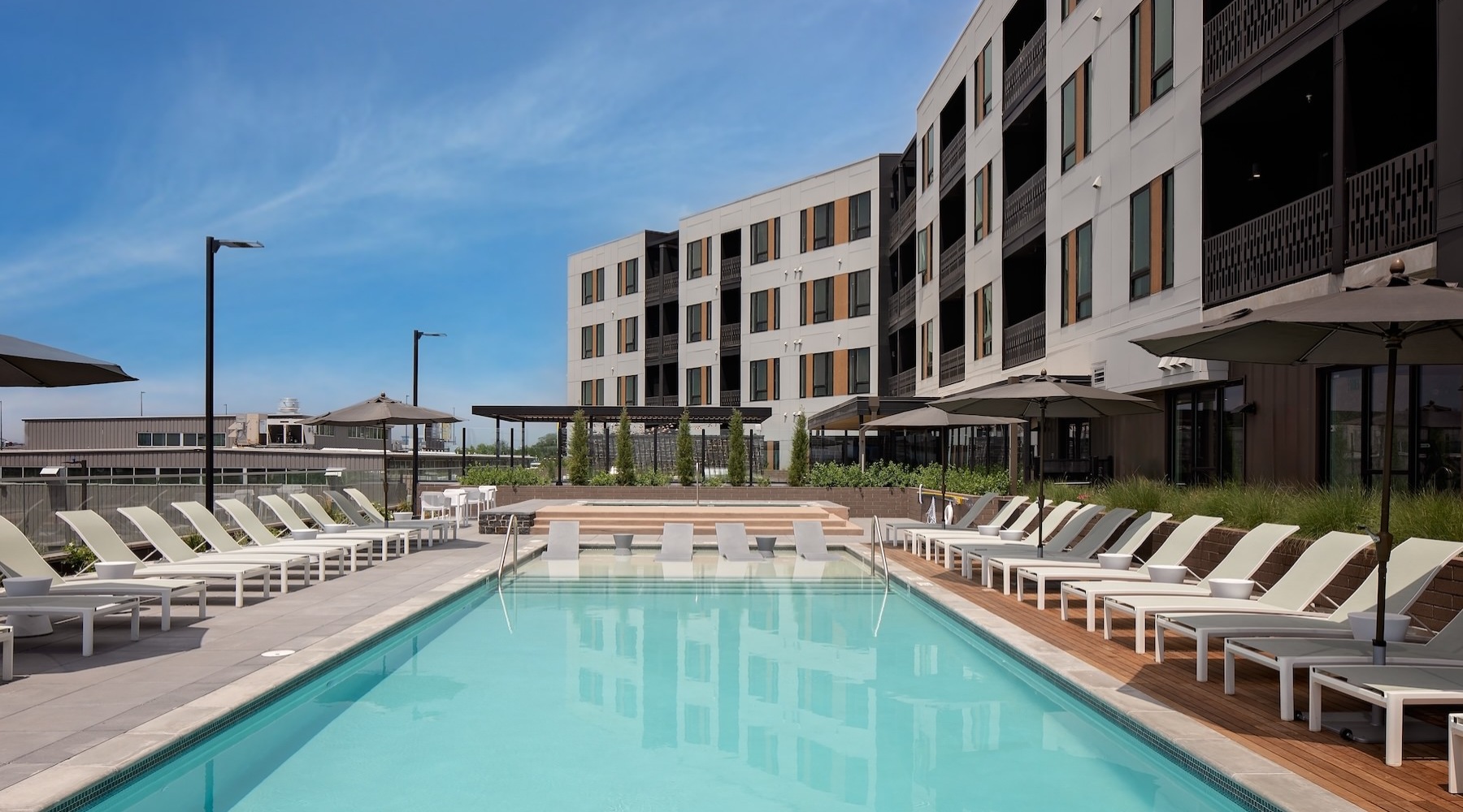 a swimming pool with lounge chairs