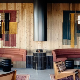 a clubroom with couches, tables and chairs
