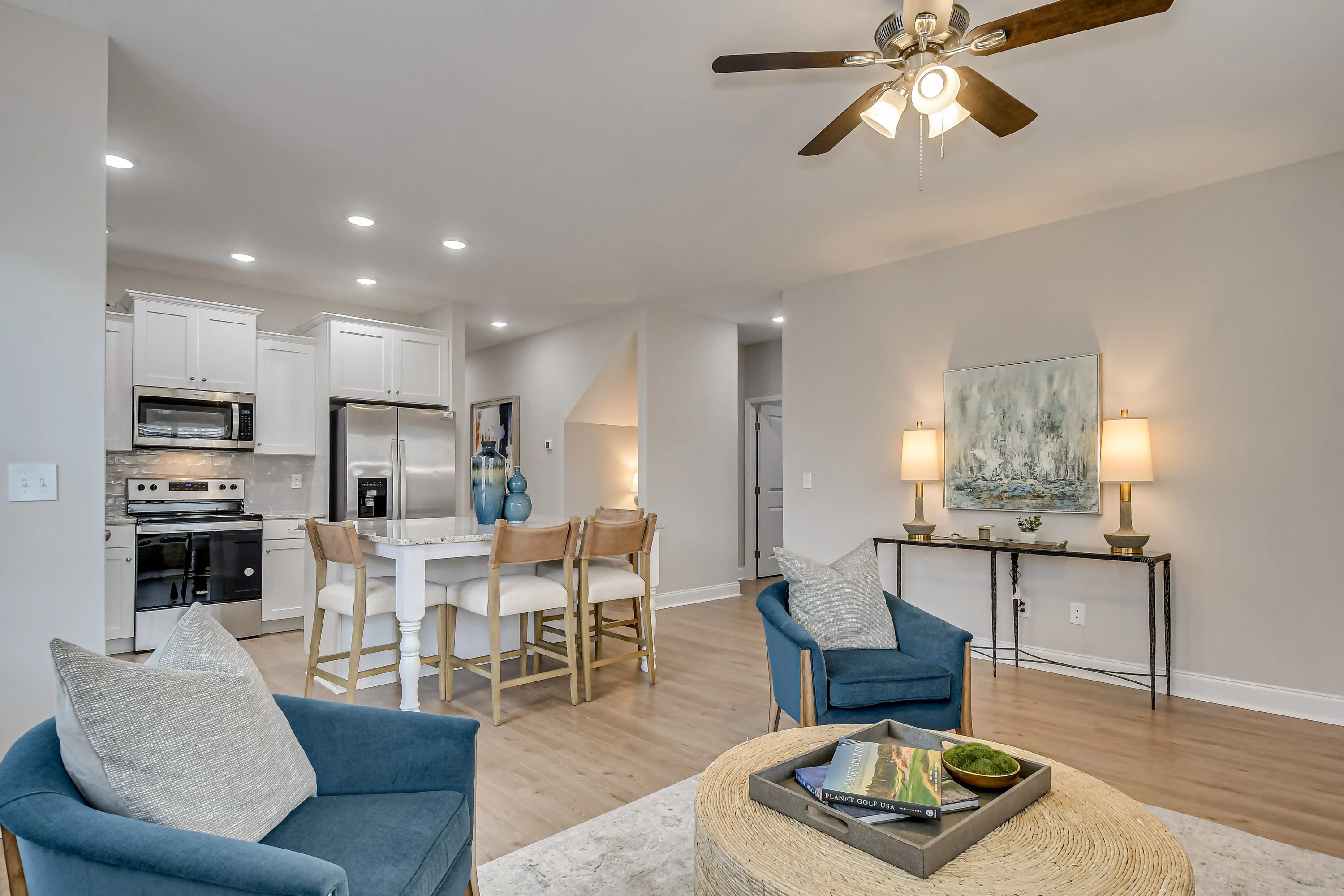 Apartment interior featuring an open living space, kitchen with stainless steel appliances, and cozy seating area.