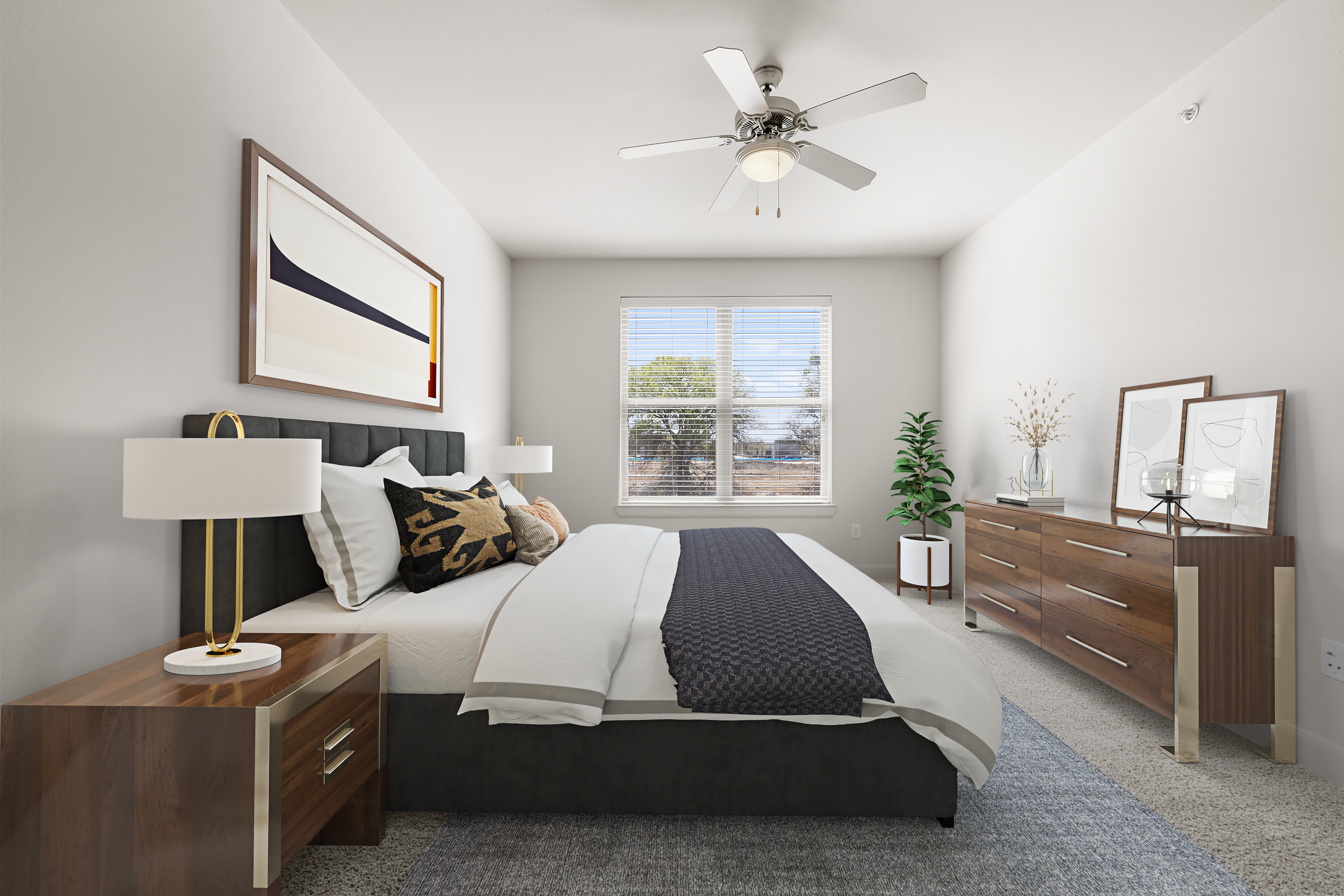 Modern primary bedroom with ceiling fan and carpet.