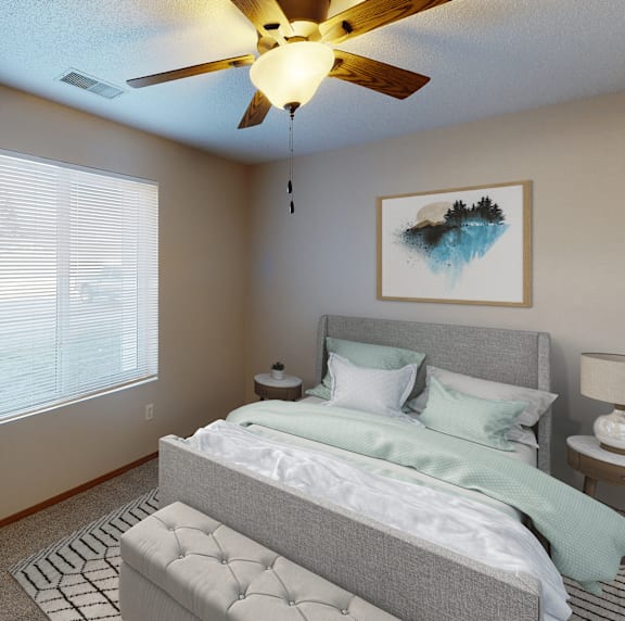 a bedroom with a ceiling fan and a bed with a blue and white comforter