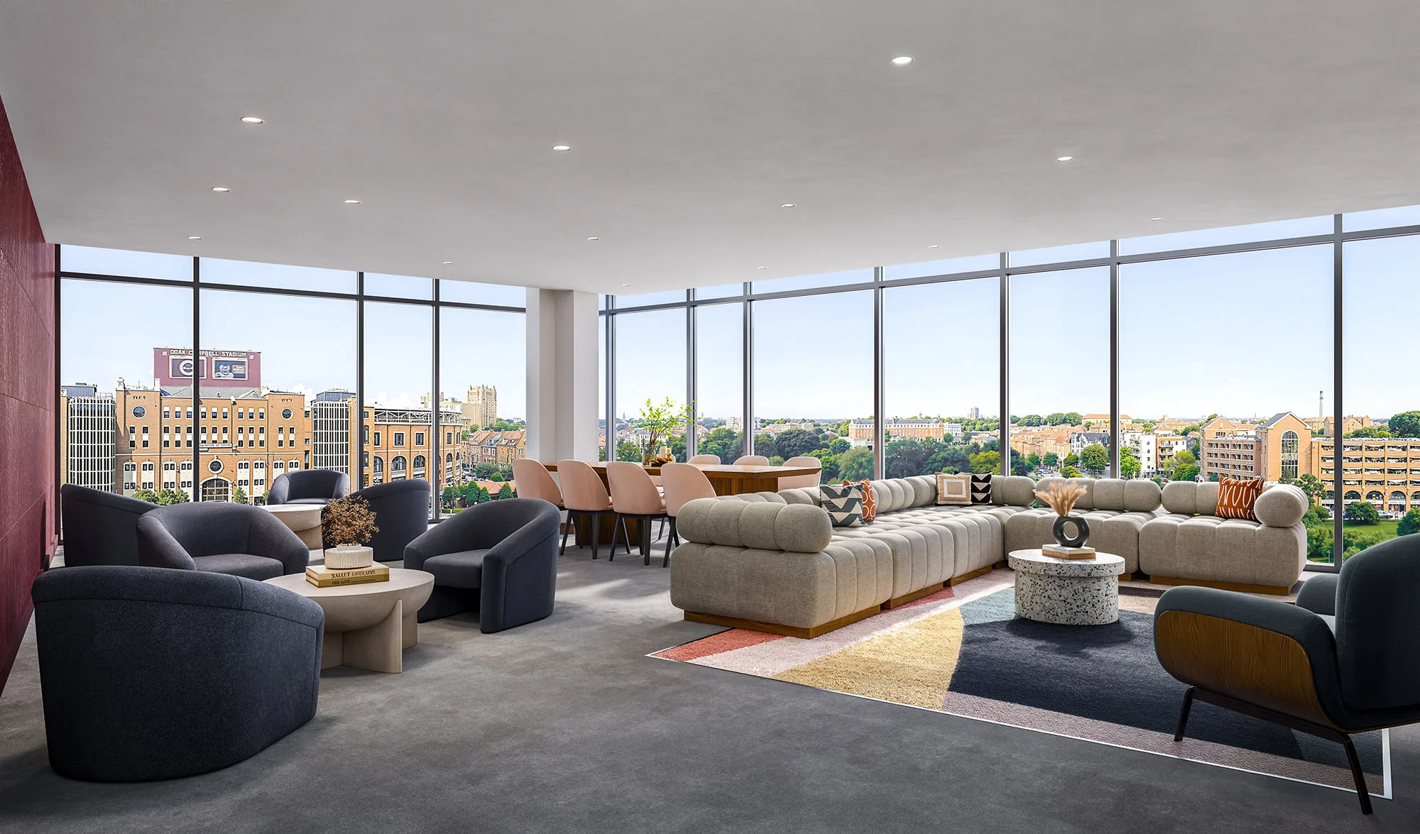 Sky lounge at Perla's luxury Tallahassee, FL, student apartments near the FSU campus, featuring L-shaped couches, tables, and chairs, and a view of the FSU football stadium